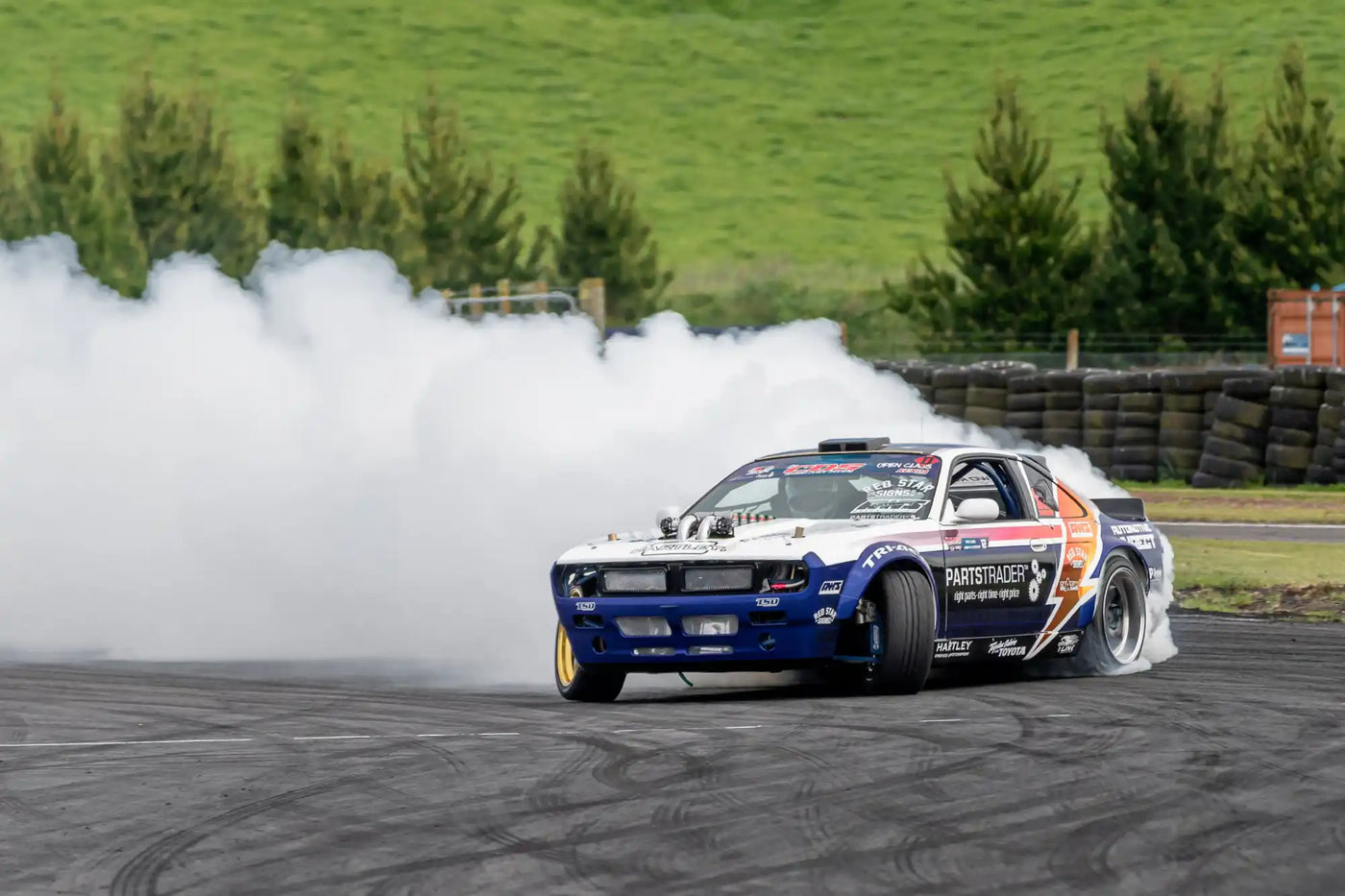 Drifting race car with smoke.