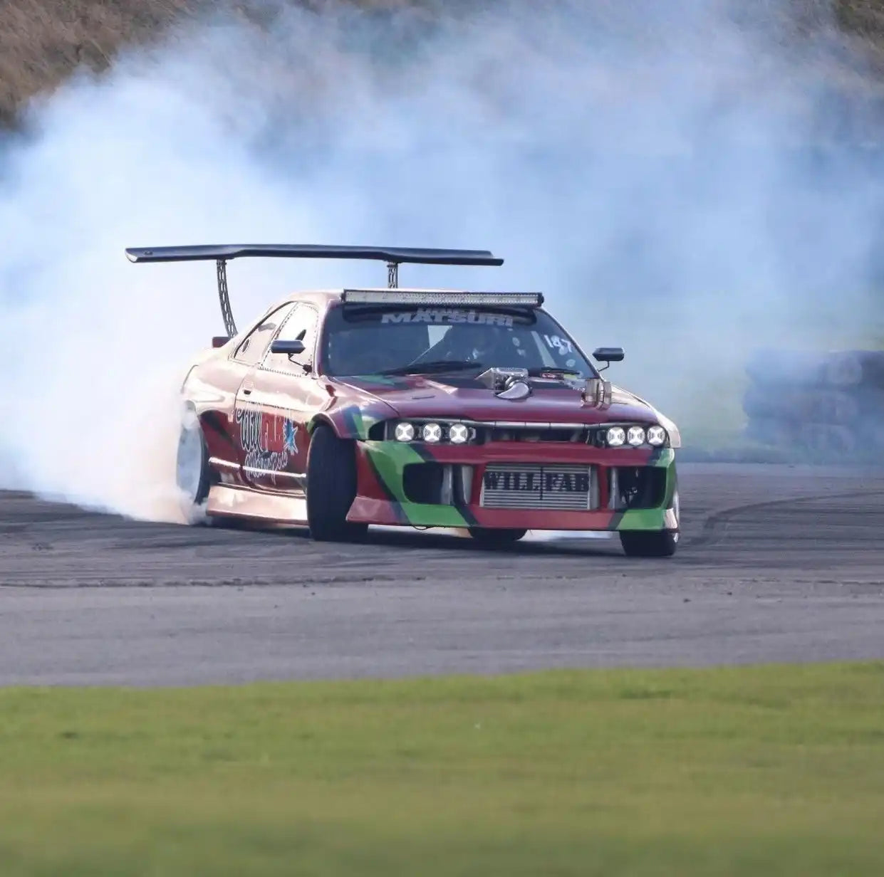 Drifting race car with spoiler.